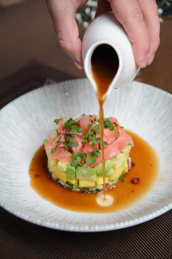 Royal Tulip Hotel & Casino, Tbilisi Bagian luar foto Soy sauce being drizzled over a sushi dish