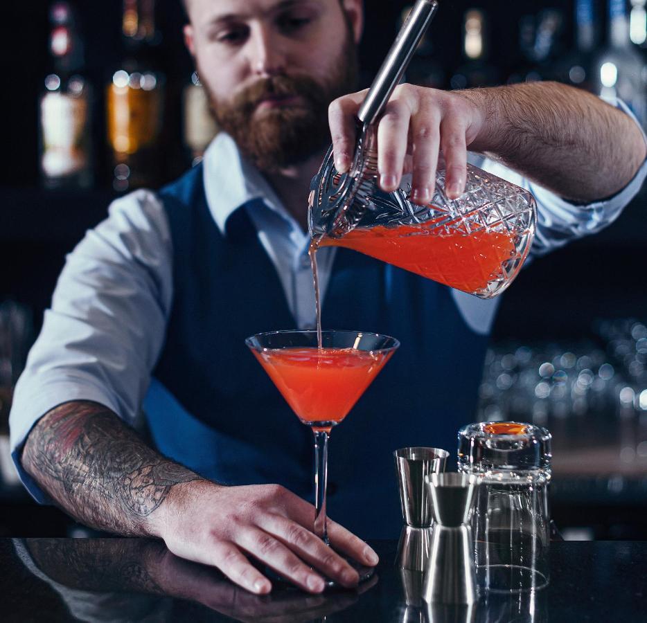 Royal Tulip Hotel & Casino, Tbilisi Bagian luar foto A bartender preparing a cocktail